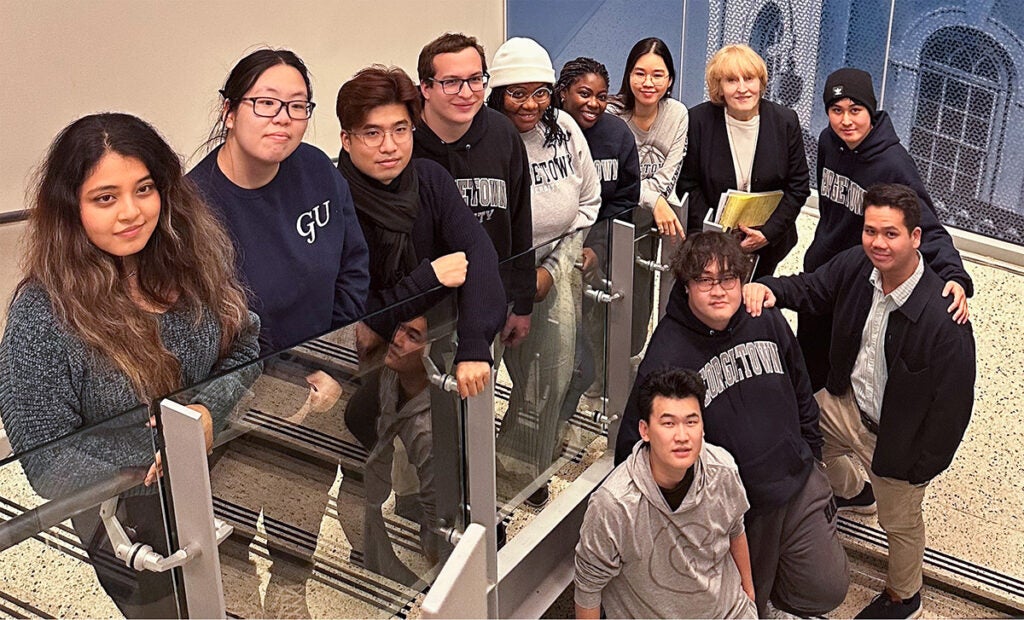 Biotechnology December 2024 graduating students pose with Dr. Labuda on a flight of stairs.